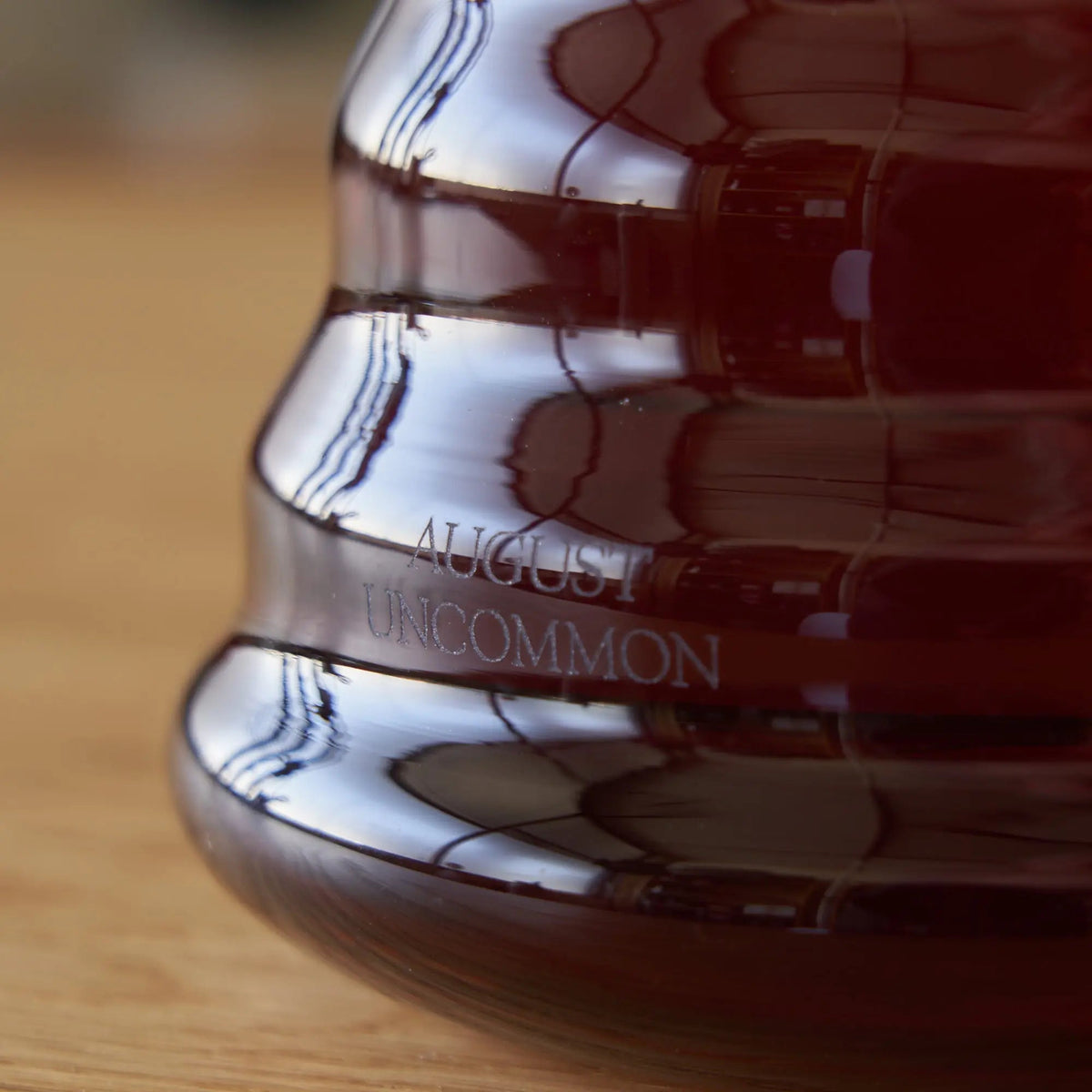 Close-up of August glass teapot with tea and brand mark