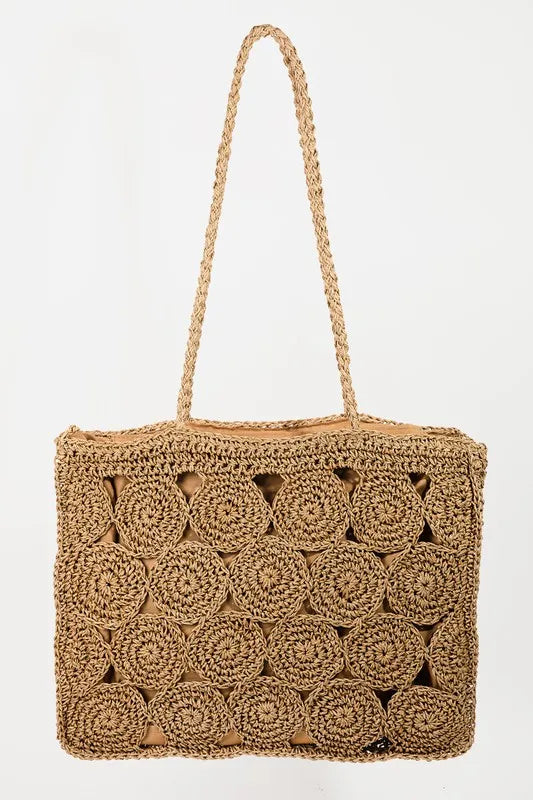 Front view of a natural-tan tote with circular braided panels and two long braided handles.