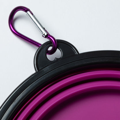 Close view of the carabiner and silver gate attached to the pet bowl's black rim.