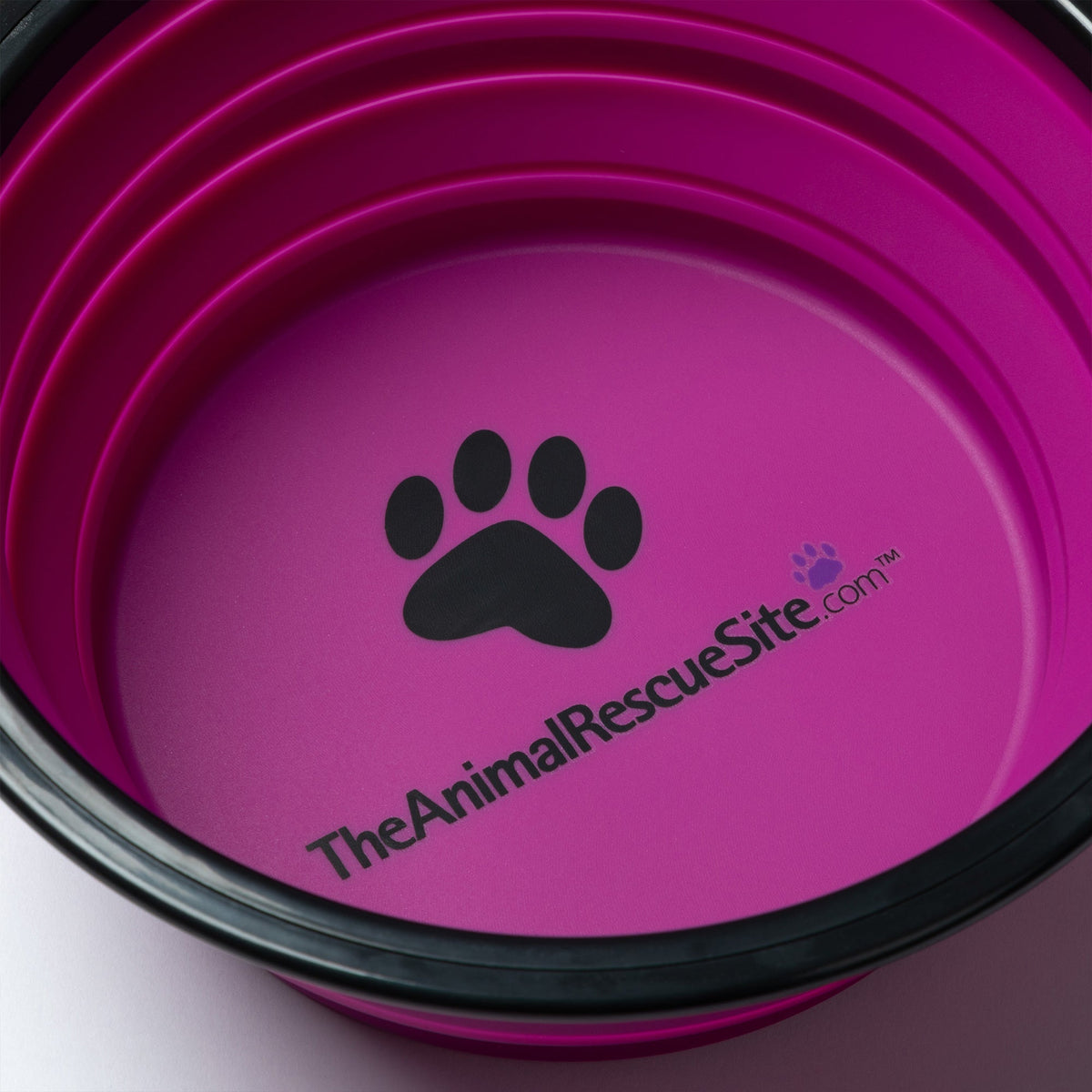 Close view of the paw design and TheAnimalRescueSite.com print inside the pink pet bowl.