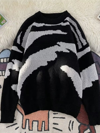 Front view of a black men's round-neck sweater with a light-gray abstract knit pattern; background rugs are not included.