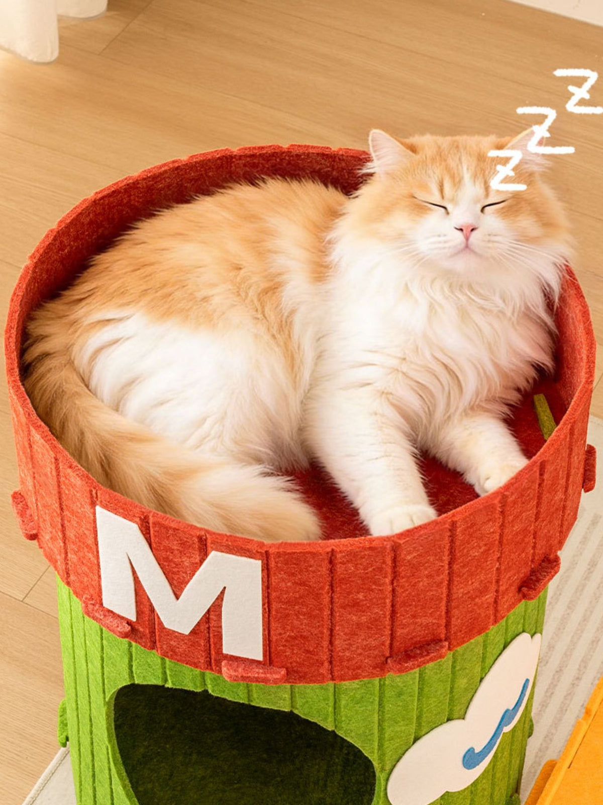 Cat resting in the top of the barrel-shaped house