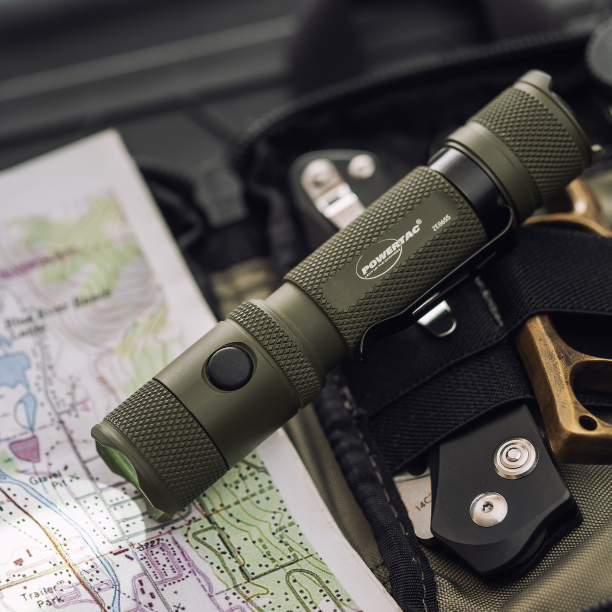 OD Green Powertac M5 Gen3 flashlight with outdoor navigation gear