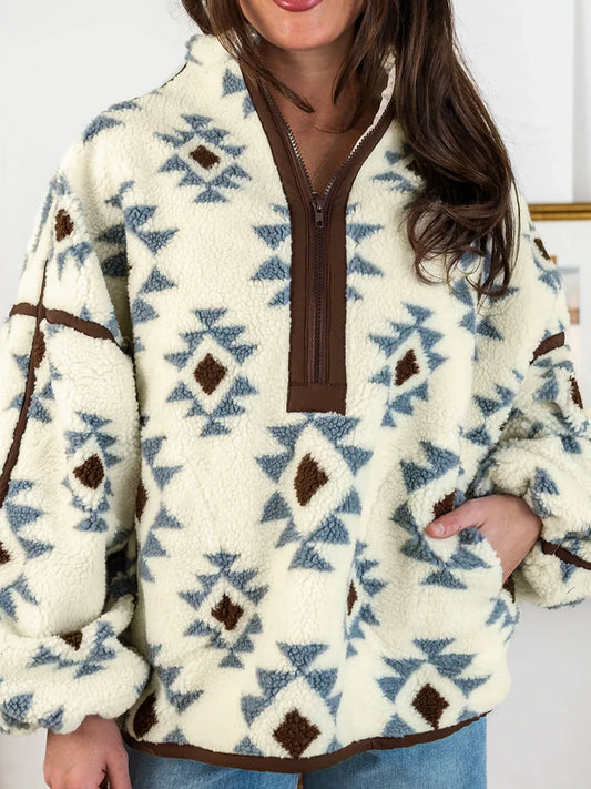 Front view of the beige SYNZ sherpa sweatshirt with blue and brown geometric motifs, short zip neckline and front pocket.