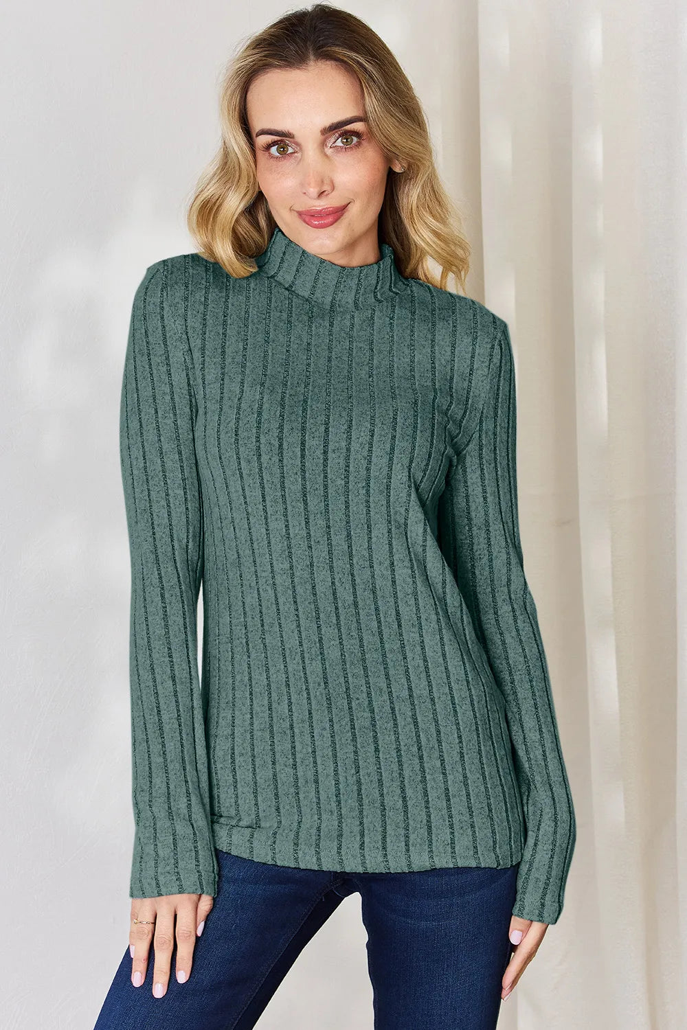 Turquoise ribbed mock-neck long-sleeve top, product view; one top included, jeans and accessories excluded