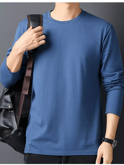 Dusty Blue men's cotton long-sleeve crewneck tee, front view with a styling bag.