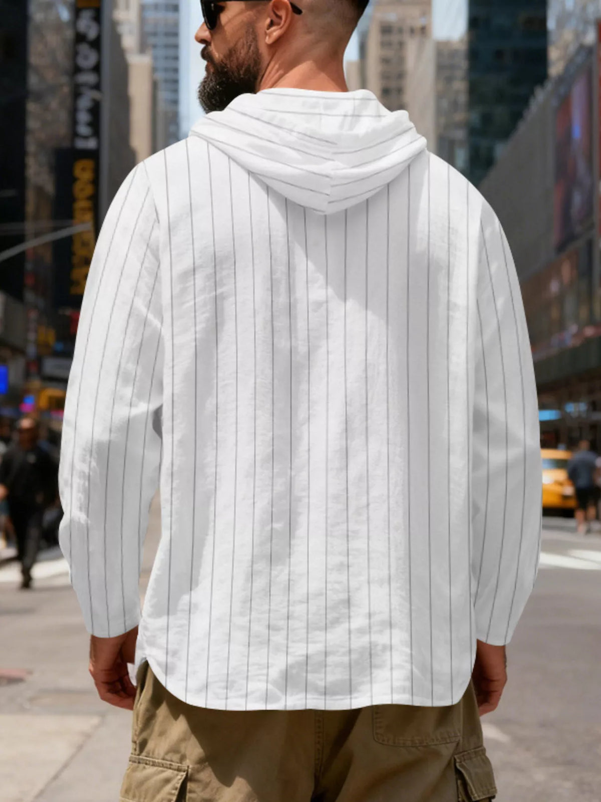 Men's striped Henley hoodie in White — back view showing the hood and vertical stripe pattern; trousers and accessories are styling only.