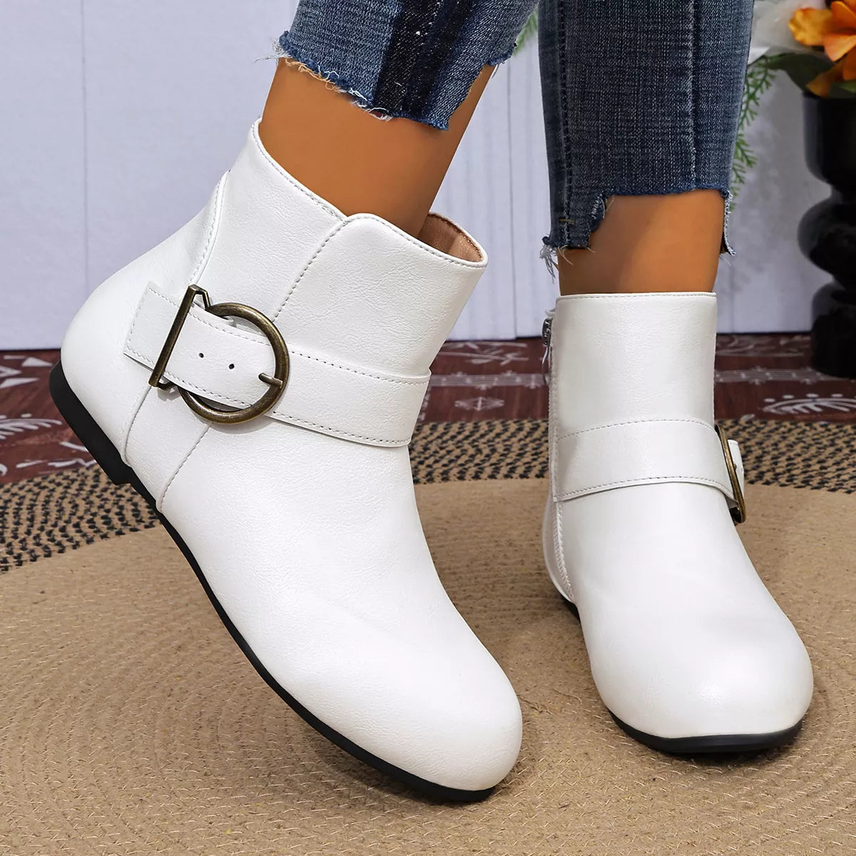 White ankle boots showing side zipper and buckle