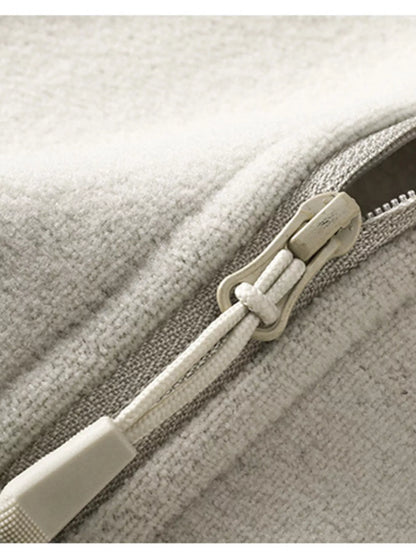 Beige sweatshirt zipper and pull detail