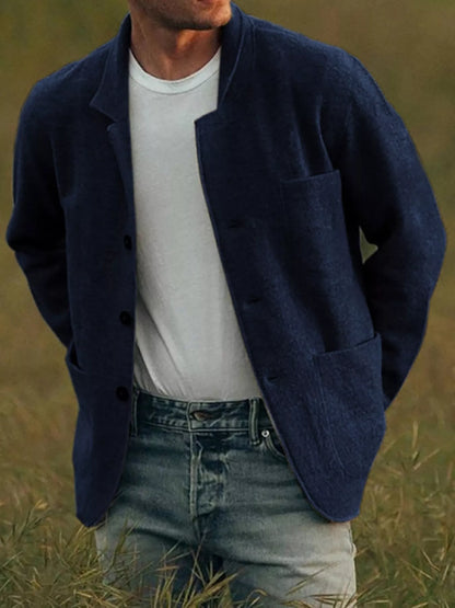 Navy men's textured button-up jacket with patch pockets, shown worn over a separate T-shirt and jeans.