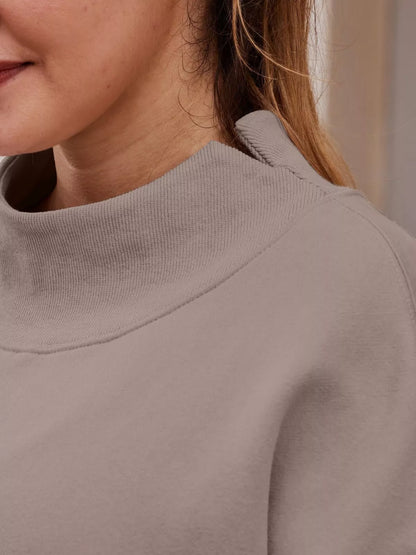 Mock-neck dropped-shoulder sweatshirt with long sleeves.