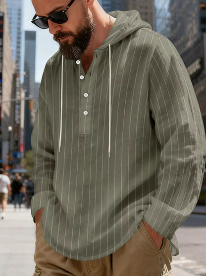 Men's striped Henley hoodie in Army Green — angled front view showing the hood and buttoned neckline; trousers and accessories are styling only.