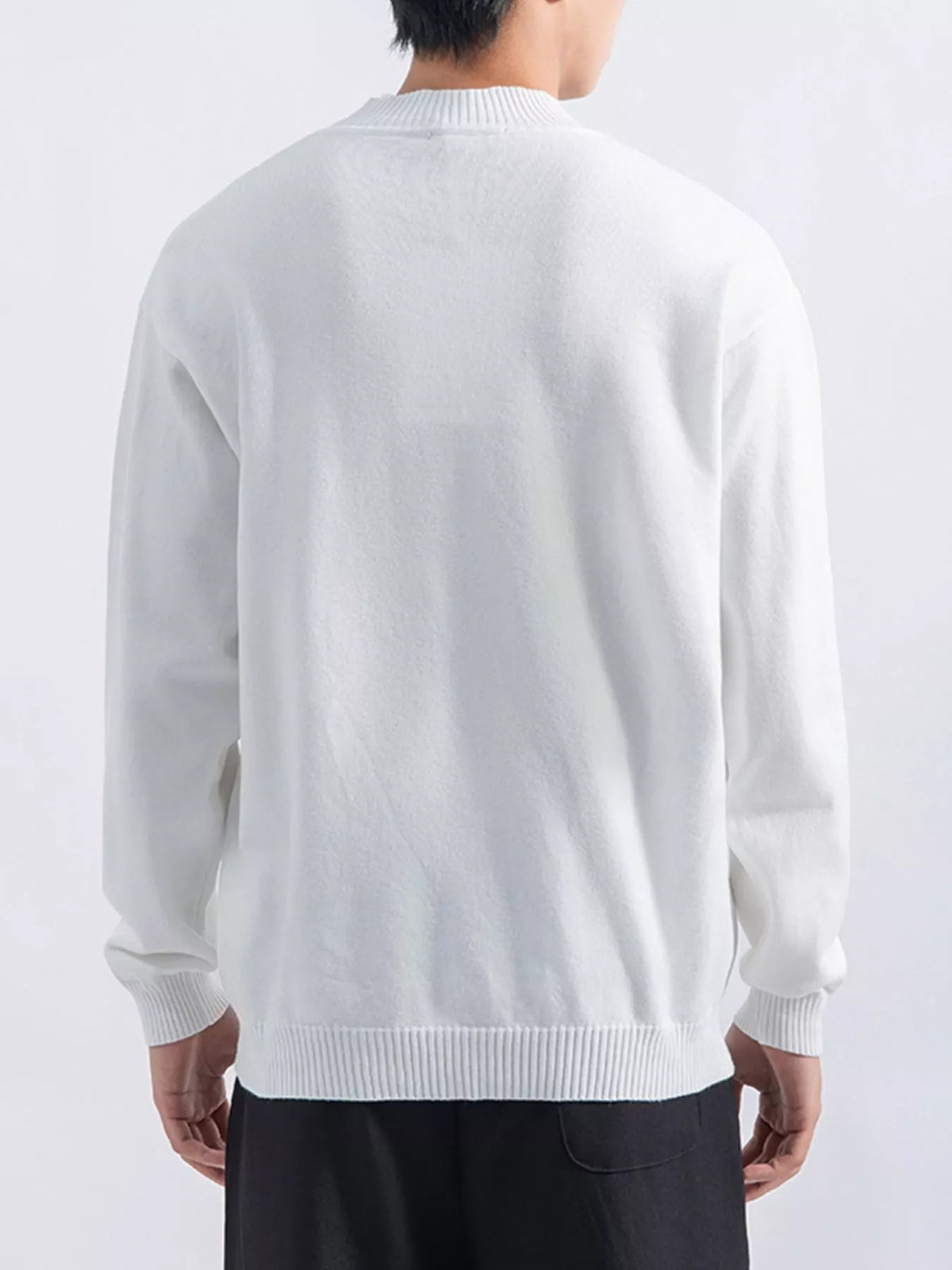 Men's White minimalist mock-neck sweater, back view. Trousers are styling items and are not included.