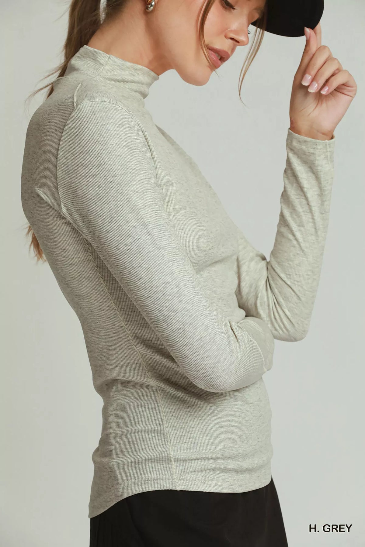 Side view of the heather-gray mock-neck top with long sleeves and side ruching. Top only.