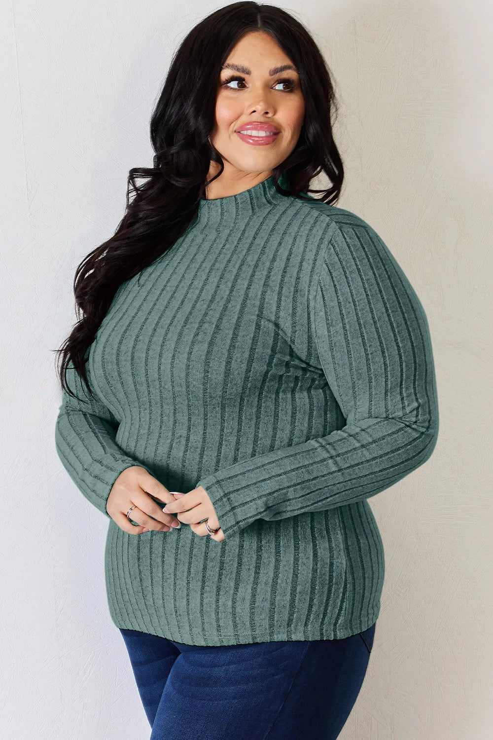 Turquoise ribbed mock-neck long-sleeve top, product view; one top included, jeans and accessories excluded