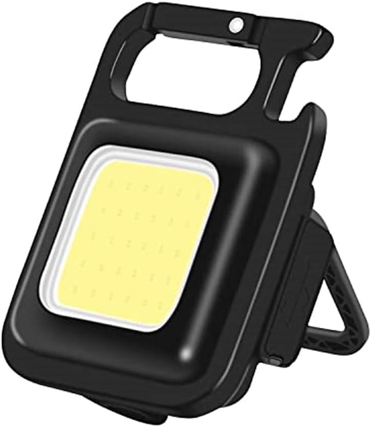 Black rectangular COB keychain light with carabiner opening and fold-out rear support.