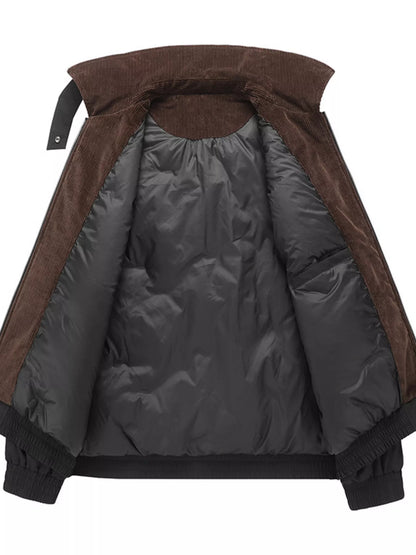 Open interior of the black jacket, showing dark lining and brown corduroy collar and facing