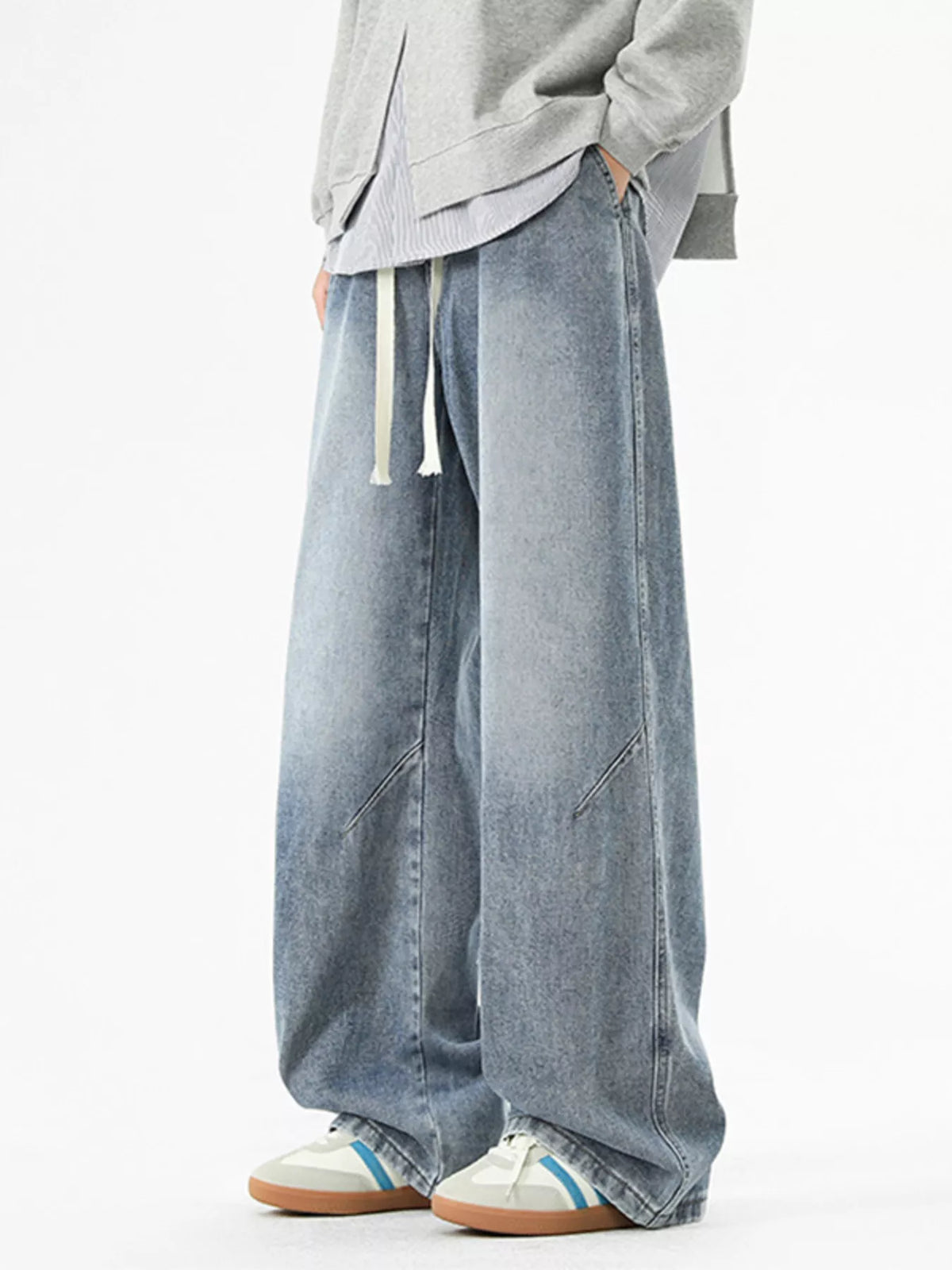 Vintage Blue men's drawstring jeans, close view of the front and wide-leg cut.