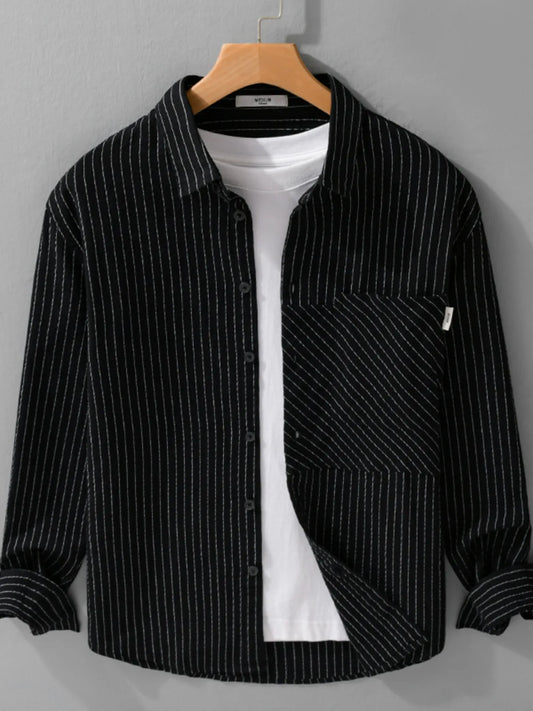 Black striped button-up shirt on a hanger with a chest pocket, styled over a white T-shirt that is not included.