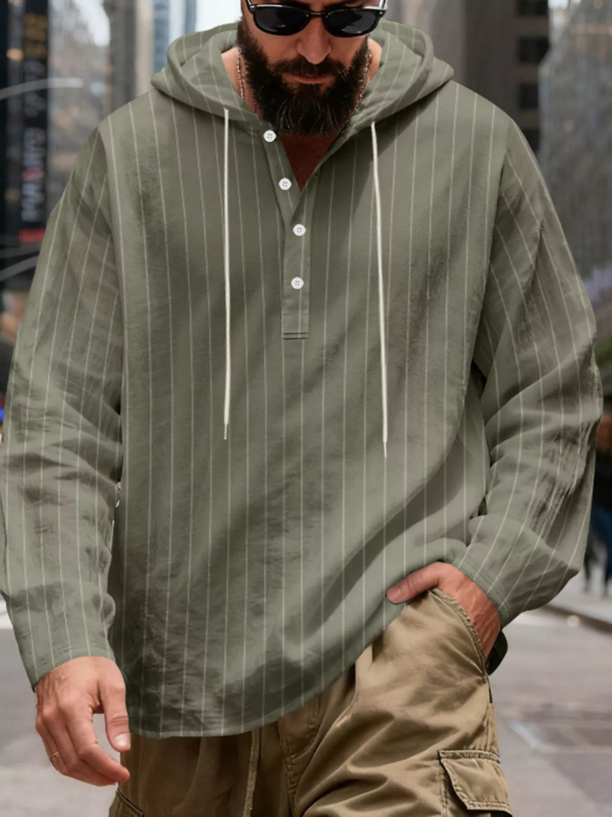 Men's striped Henley hoodie in Army Green — front view showing the hood and buttoned neckline; trousers and accessories are styling only.