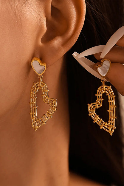 Gold-tone heart drop earrings with pale heart-shaped studs and open wrapped-wire heart pendants, shown worn.