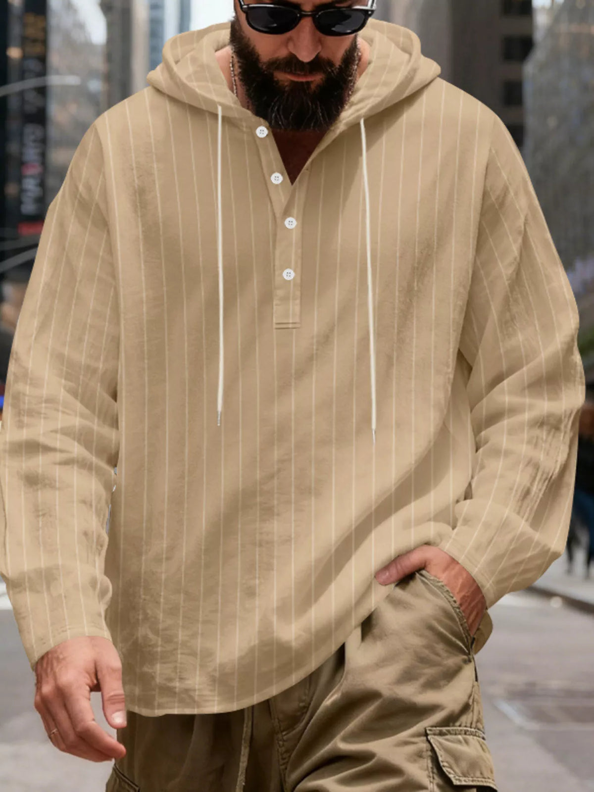 Men's striped Henley hoodie in Khaki — front view showing the hood and buttoned neckline; trousers and accessories are styling only.