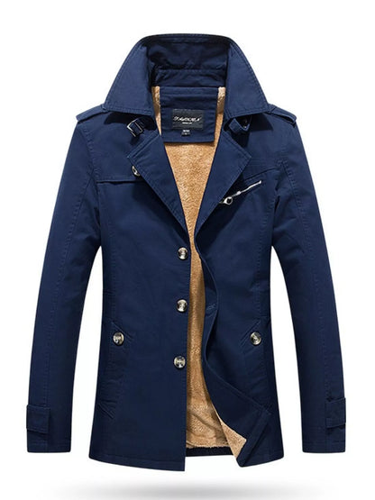 Blue long-sleeve coat shown from the front, with a high collar, button front, pockets and a zippered chest detail.