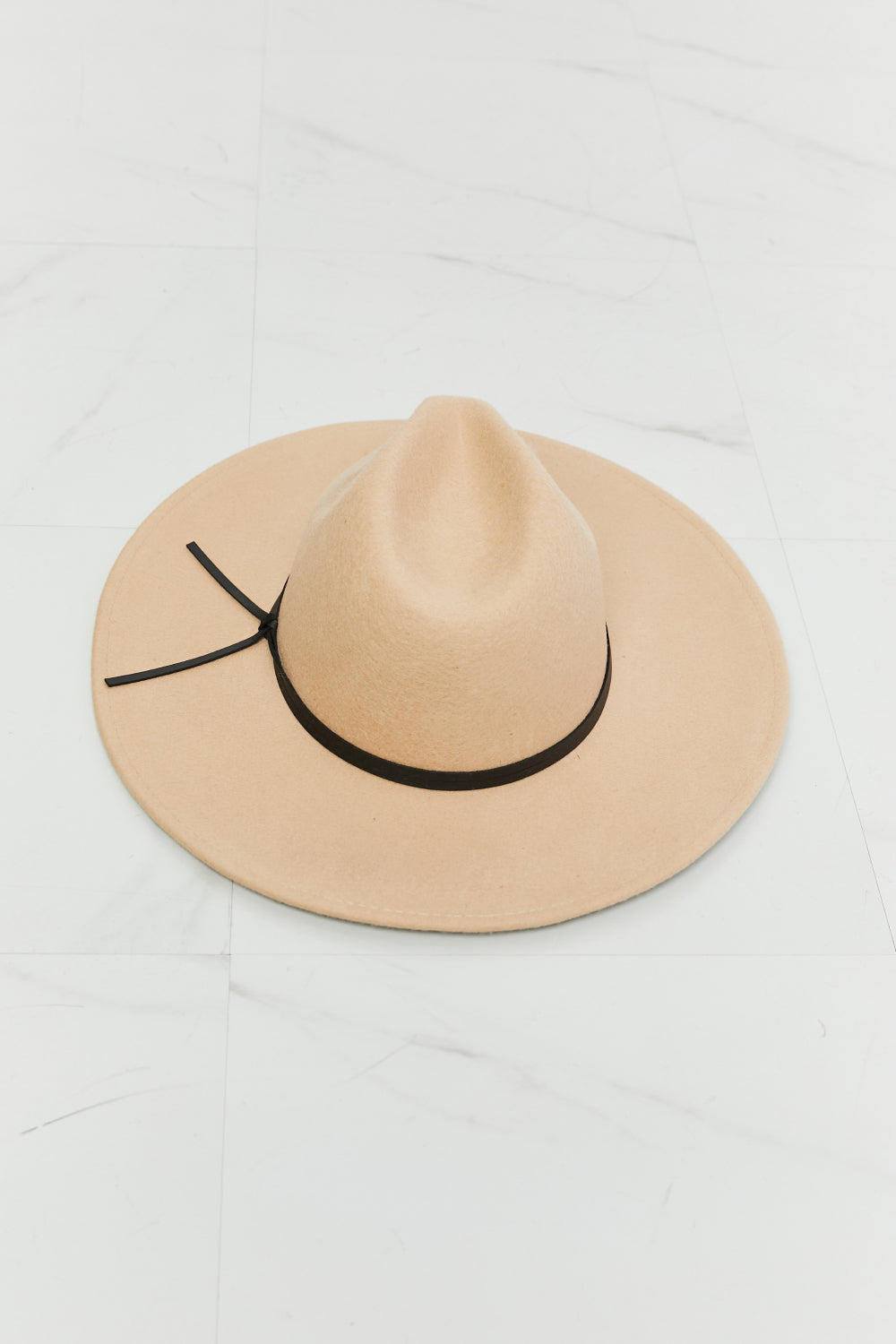 Beige Fame fedora with black band, angled view