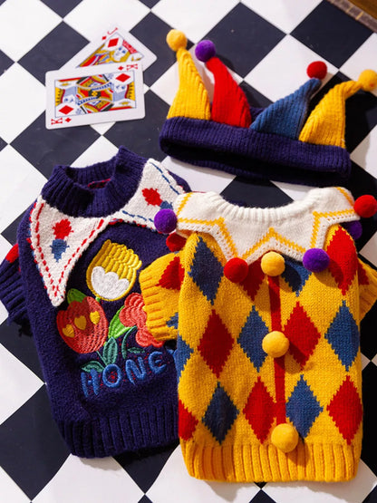 Yellow diamond-pattern and navy fruit-design pet sweaters shown together; pictured accessories may depend on the selected option.