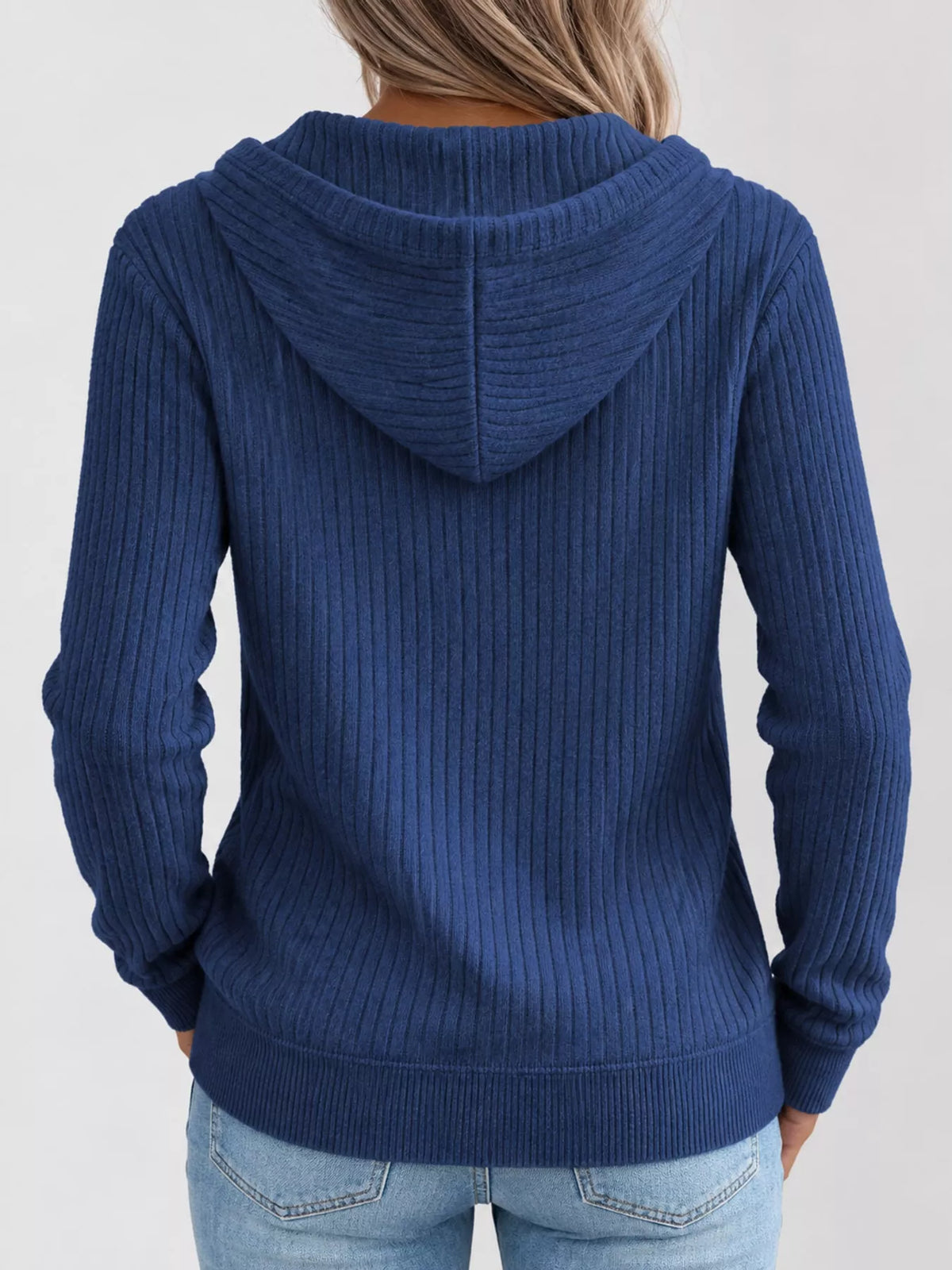 Back view of the blue ribbed zip-front hooded cardigan with long sleeves.