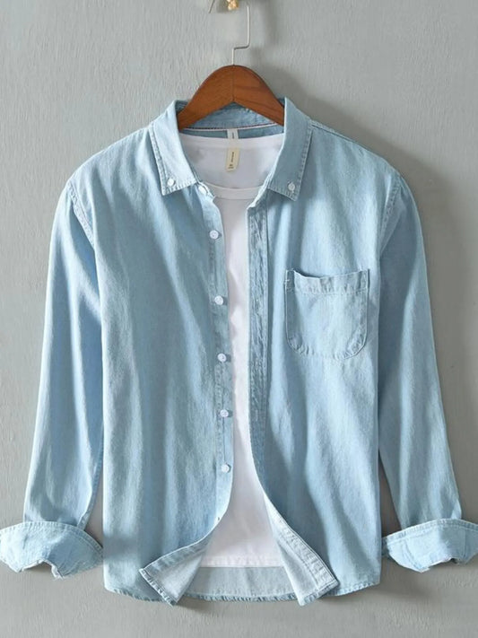 Light Blue denim shirt on a hanger, front view over a white T-shirt
