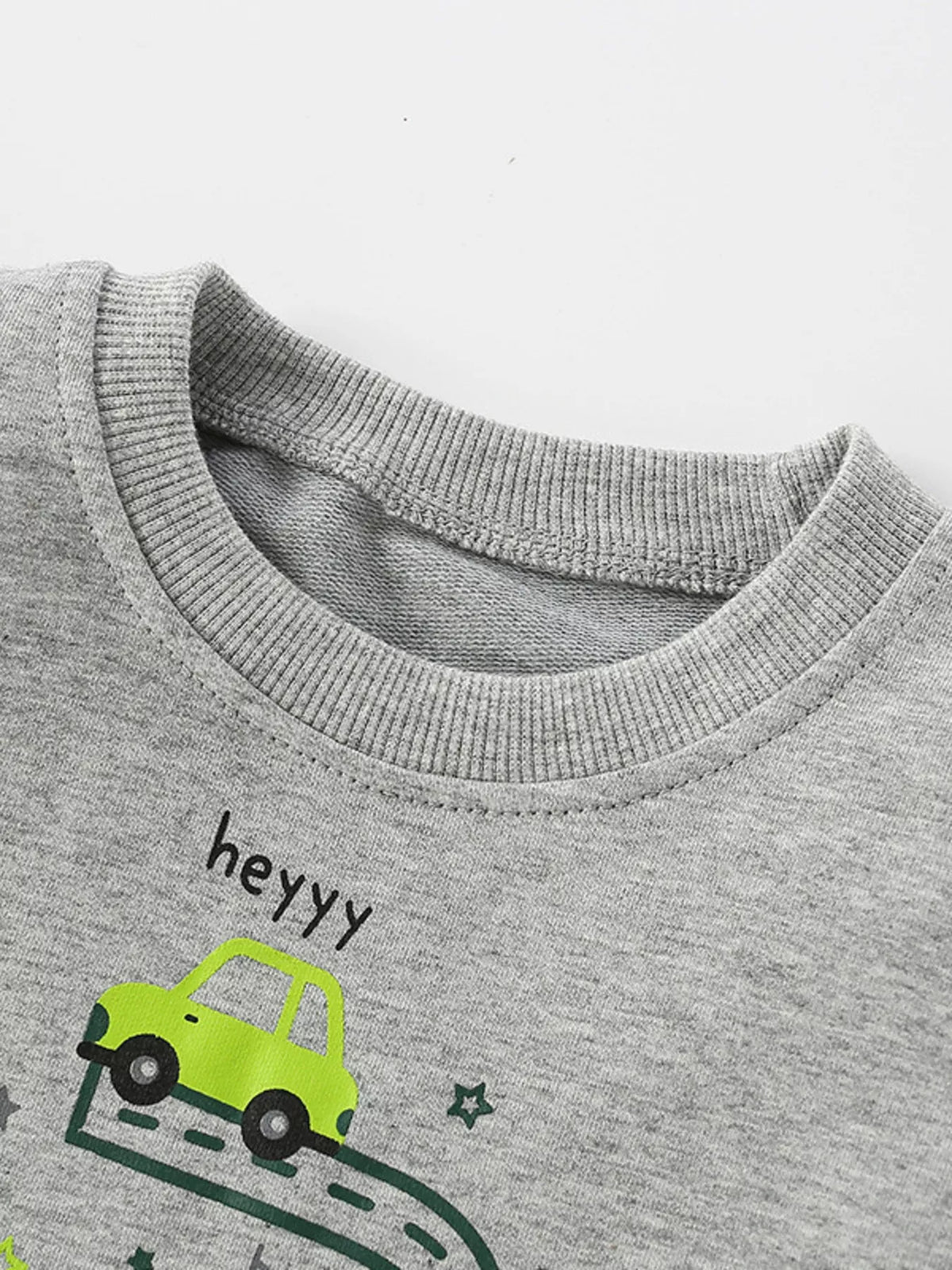 Close view of the sweatshirt's ribbed crew neckline and gray fabric.