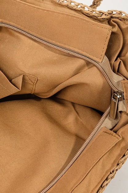Close-up of the tote's tan lining, inner pocket and zip-top opening.