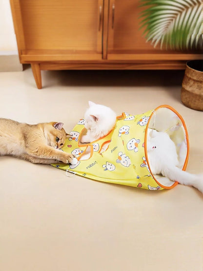 Rabbit-pattern yellow collapsible cat tunnel with orange trim, shown with cats for scale; one tunnel included