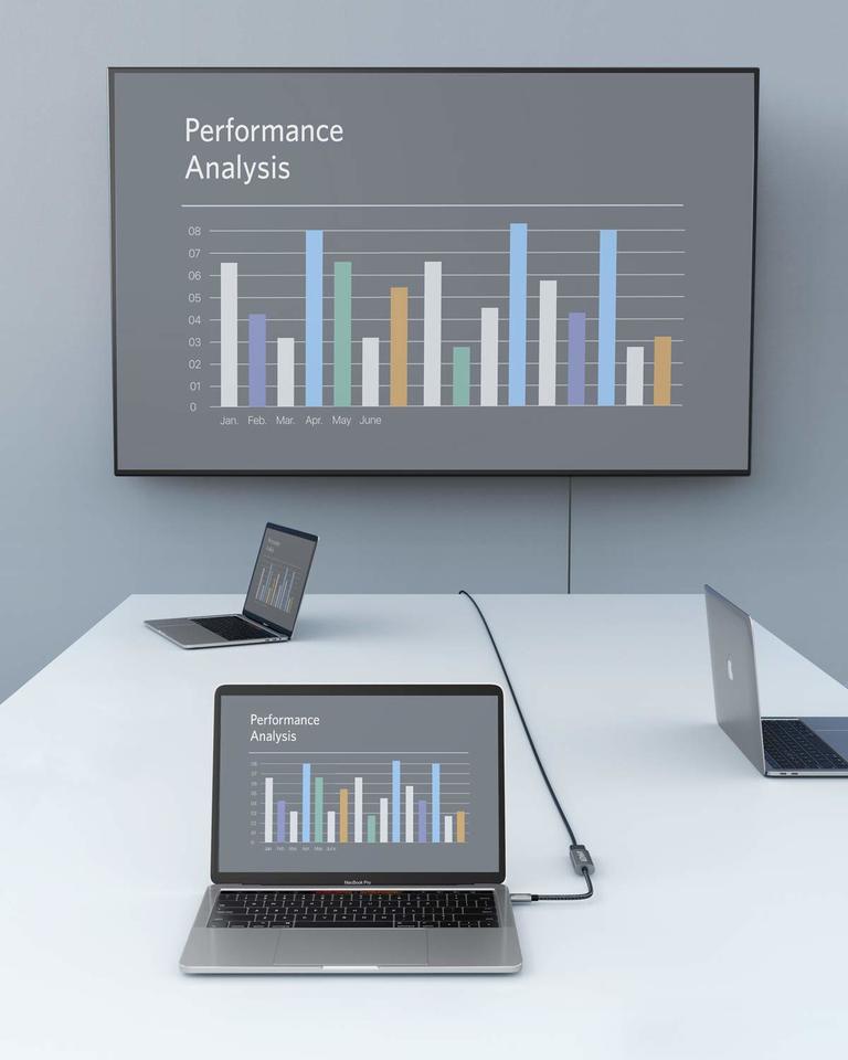 Black Anker USB-C to HDMI adapter connecting a laptop to an external display; computer, display and HDMI cable not included.