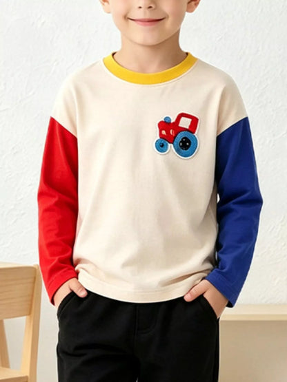 Cream children's crewneck sweatshirt with a tractor applique and contrasting red and blue sleeves, shown worn; trousers are not included.