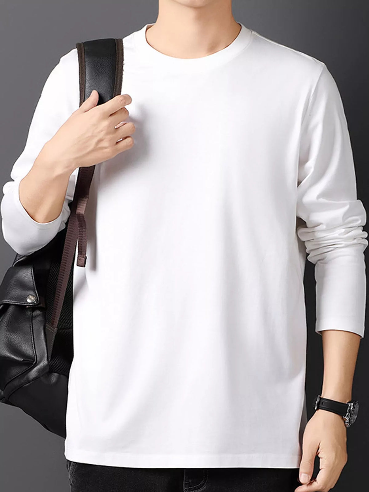 White men's cotton long-sleeve crewneck tee, front view with a styling bag.