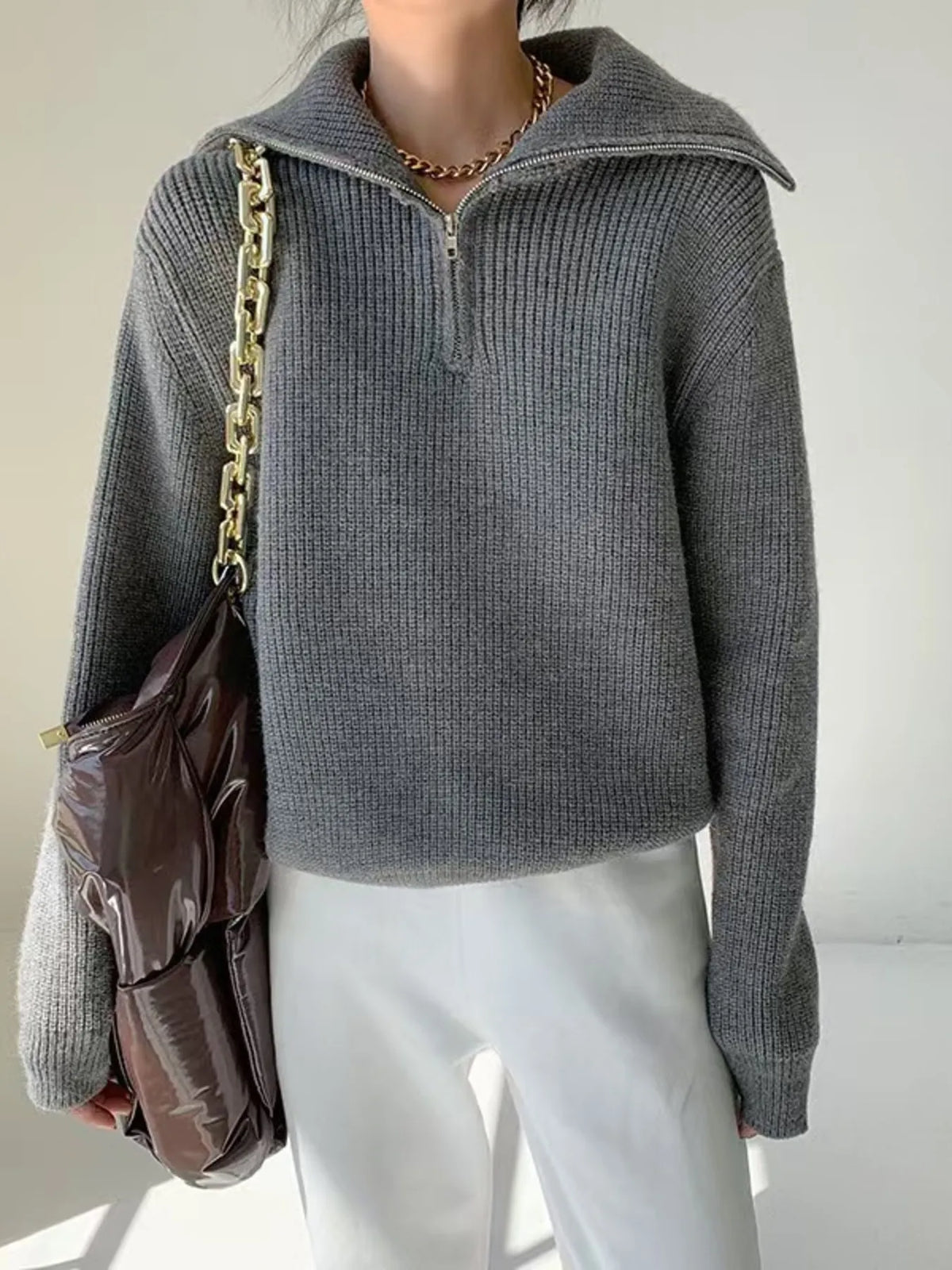 Half-zip long-sleeve ribbed sweater with a high collar.