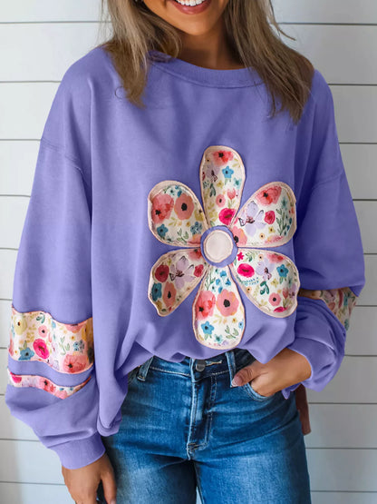 Lavender floral applique sweatshirt, front view with round neck and long sleeves. Trousers are styling only.
