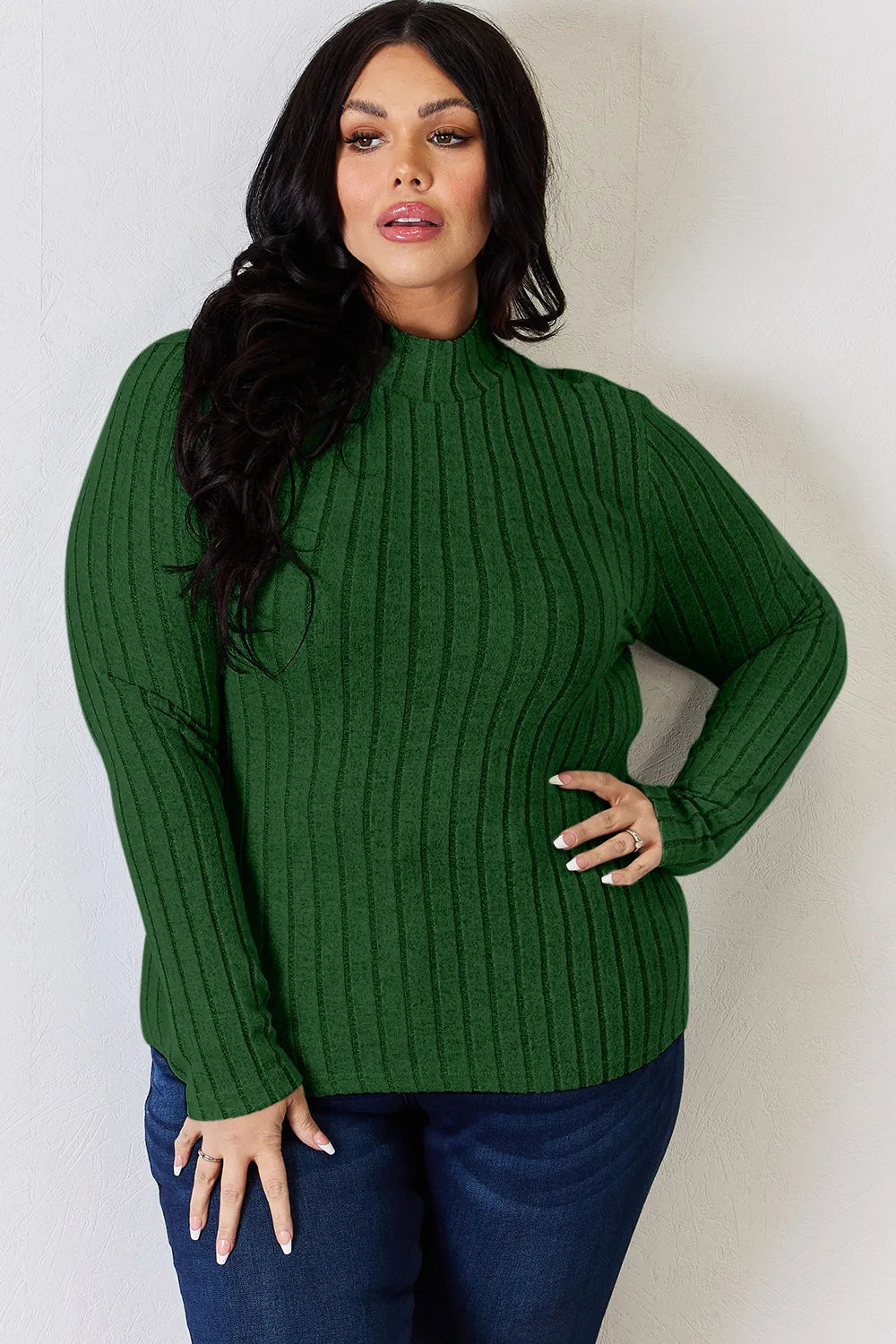 Green ribbed mock-neck long-sleeve top, product view; one top included, jeans and accessories excluded