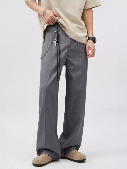Grey wide-leg trousers, front view with belt chain styling