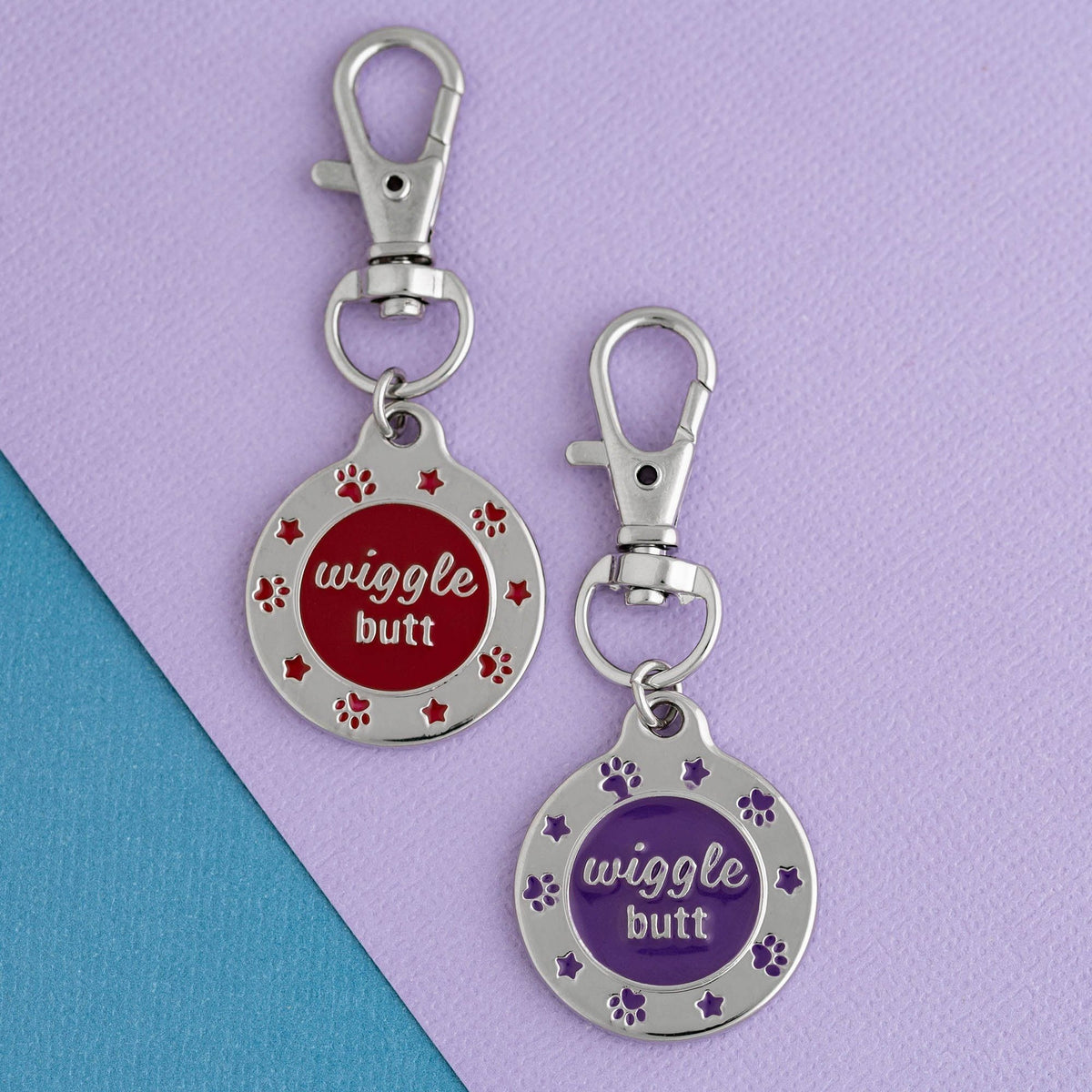 Red and purple Wiggle Butt enamel pet tags shown side by side as color options; select one tag.