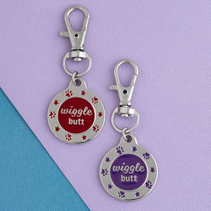 Red and purple Wiggle Butt enamel pet tags shown side by side as color options; select one tag.