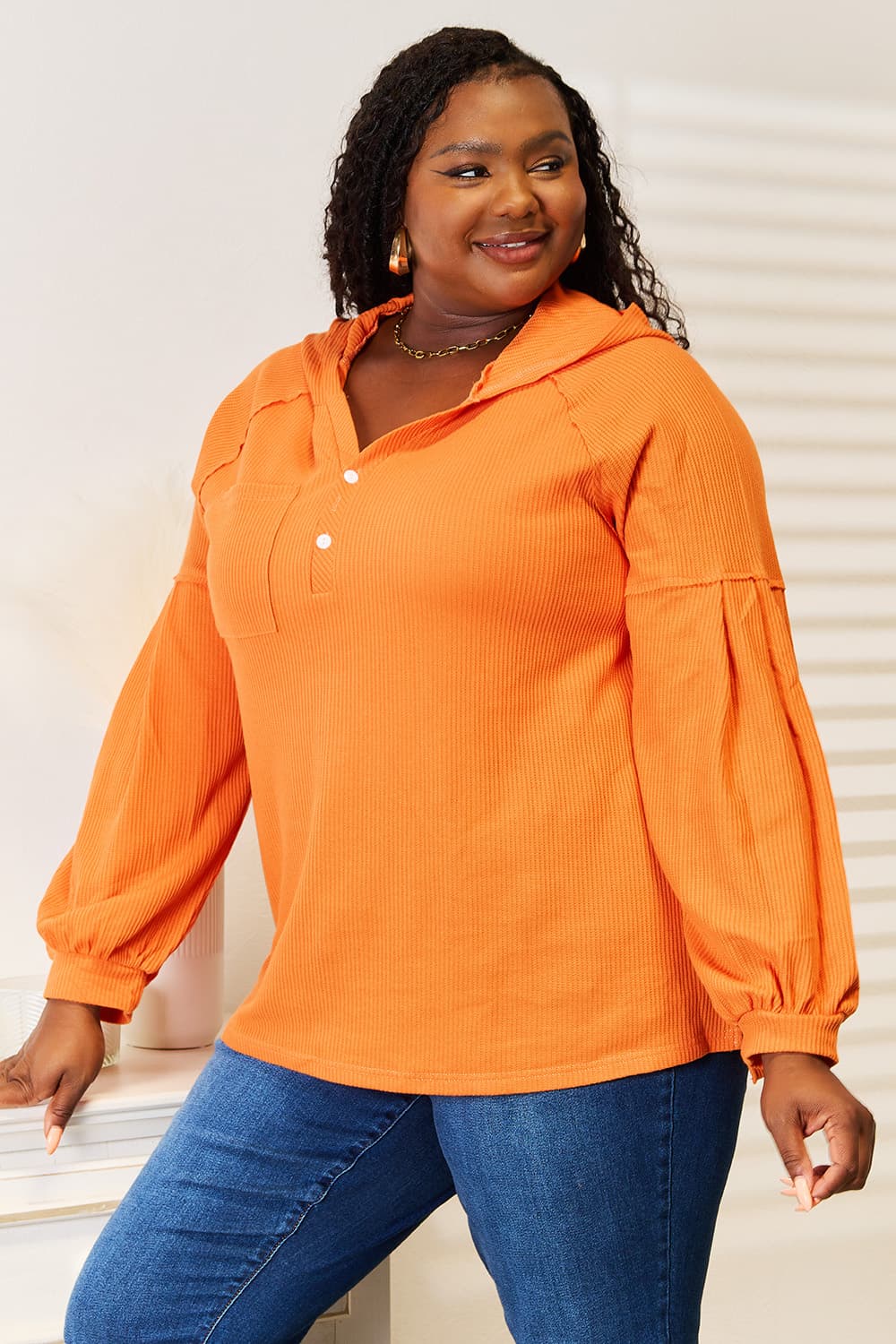 Orange waffle-knit hoodie, angled front view
