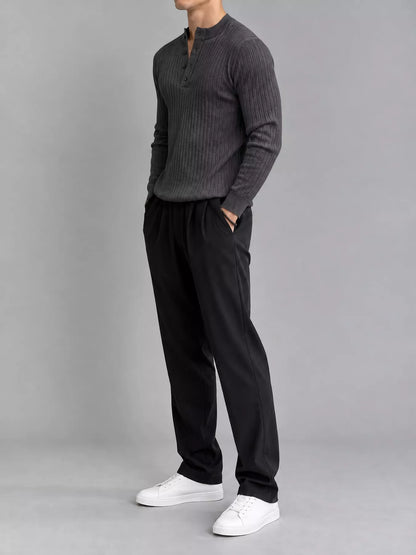 Dark gray ribbed long-sleeve knit top with button detailing, modelled angled front view. One top only; styling pieces not included.