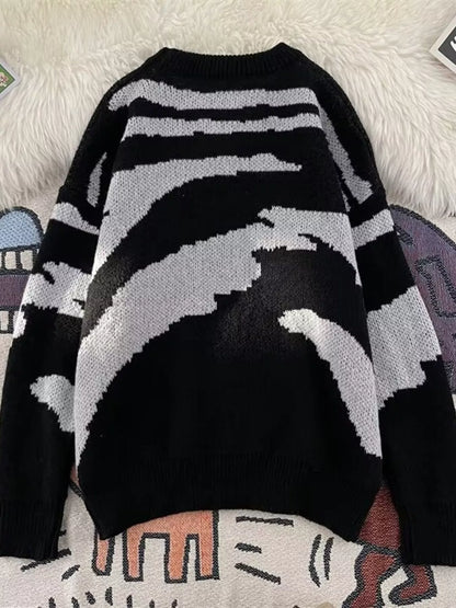 Back view of the black and light-gray patterned sweater with ribbed hem and cuffs.