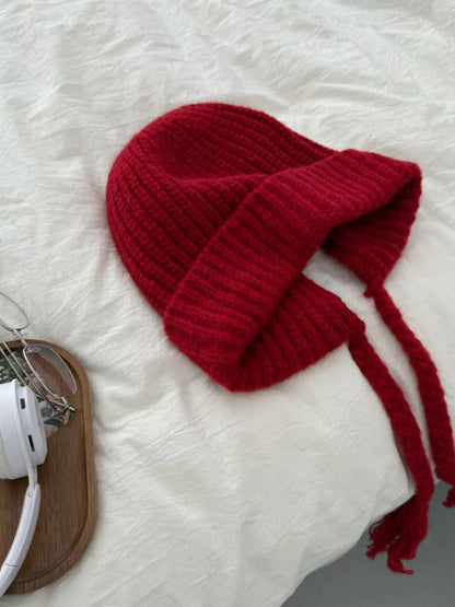 Red ribbed knit beanie with long braided ties