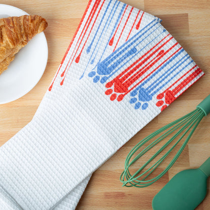 Painted Paws kitchen towels on a counter; food and utensils are styling props.