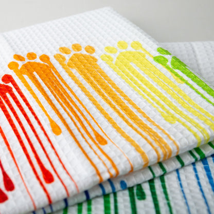 Close-up of the Rainbow Paws towel print and waffle weave.