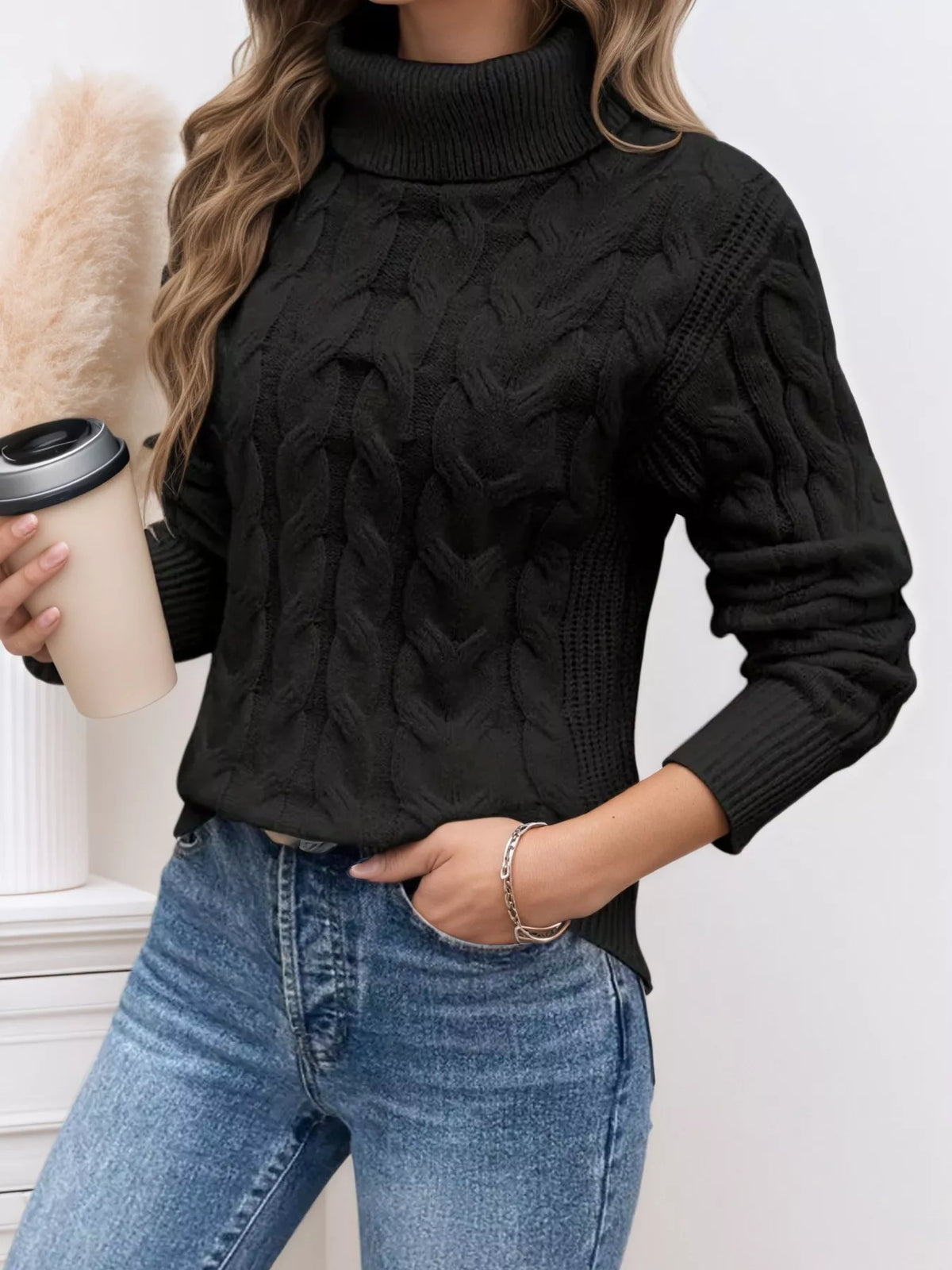 Cable-knit turtleneck sweater with long sleeves.